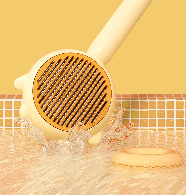 Yellow handheld shower scrubber with water splashes on a yellow background